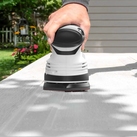 Person using Electric Detail Sander With 12-Piece Sandpaper Set 60 80 100 120 Grit 14,000 OPM on wood surface