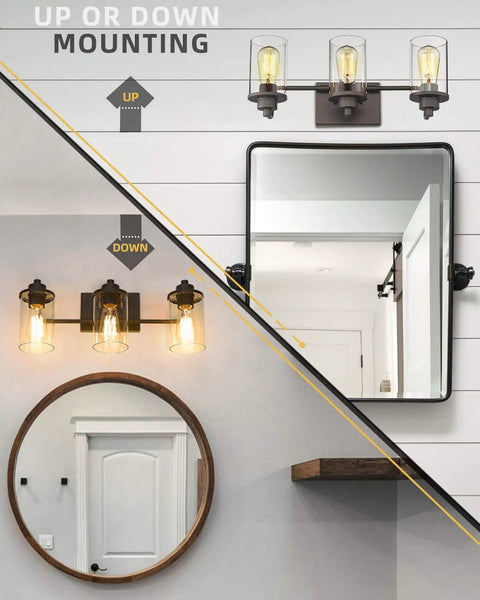 Three Light Farmhouse Vanity Light Fixture For Bathroom Wall Mount In Oil Rubbed Bronze With Clear Glass Shades, Durable Metal Build, Modern Rustic Lighting To Elevate Your Space And Up Your Bathroom Vibe, showcasing up or down installation options above mirrors.