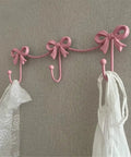 Kickass Heavy Duty Wall Mounted Coat Hook Bulletproof Metal Clothes Hanger with pink color bows, ideal for entryway organization.
