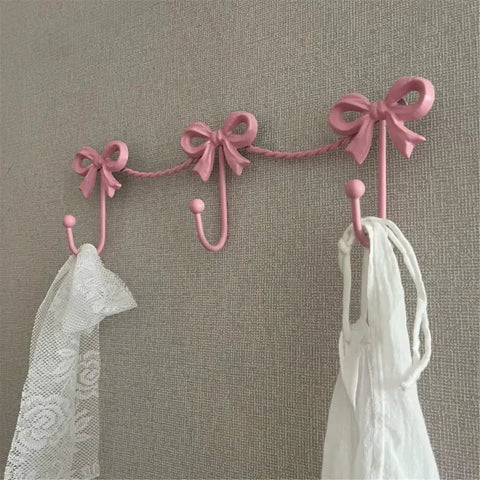 Kickass Heavy Duty Wall Mounted Coat Hook Bulletproof Metal Clothes Hanger with pink color bows, ideal for entryway organization.