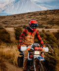 Person on a motorcycle in rugged landscape, wearing red helmet and gear, suitable for Heavy Duty UV Resistant Beefy Polyurethane Straps Set 3 Pack