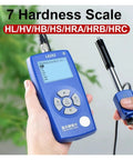 Heavy Duty Handheld Digital Metal Hardness Tester With Dual Coil Design And Wireless Print Capabilities For Steel Or Aluminum Alloy Straight Up Precision Testing in use with screen displaying hardness scales.