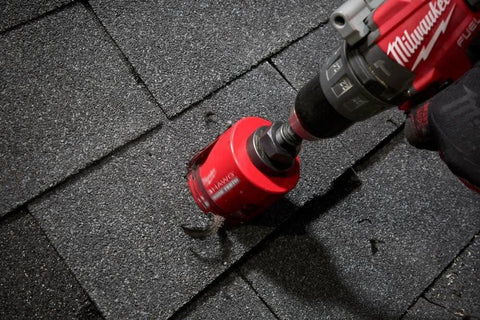 Close-up Milwaukee 4-1/4 in Big Hawg carbide hole saw attached to a drill outdoors