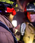 Firefighter using LED Helmet Light With 180 Degree Articulating Head And Dual Beam Output in dark environment, orange light visible