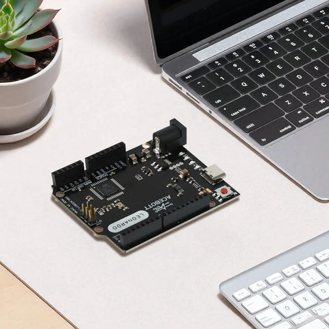 ATmega32U4 Arduino Compatible Microcontroller Board With USB Type C Cable, DIY Starter Kit, 7 To 12V Input, 16MHz Clock, 20 Digital IO Pins With PWM, 2.5KB SRAM, Ideal For Prototyping Projects And Learning Electronics. Black microcontroller board on desk beside laptop