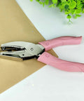 Handheld Circle Hole Punch One Ninth Inch Three Mm, pink handle, on brown paper, Single Hole Paper Punch, Easy Grip Craft And Office Tool