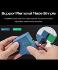 Hands demonstrating support removal from a 3D printed cube using PLA and PETG with a Crazy Color 3D Printing System for Plus4 Printer