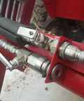 3/8 flat-face hydraulic quick-connect couplers with dust caps on a red hydraulic assembly ISO 16028/NPT front view