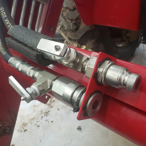 3/8 flat-face hydraulic quick-connect couplers with dust caps on a red hydraulic assembly ISO 16028/NPT front view