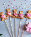 Top Tier 100 Piece 1/8 By 6 Inch Wooden Dowel Rods Smooth Bamboo Craft Sticks Bulk DIY Staple For Cake Decorating And Backyard Bosses Splinter Free Finish with bear-shaped cookies on sticks.