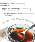 Bulk Vanilla Extract 128 Oz Gallon From Ugandan Vanilla Beans, rich creamy flavor in glass bowl with silver spoon and vanilla flower