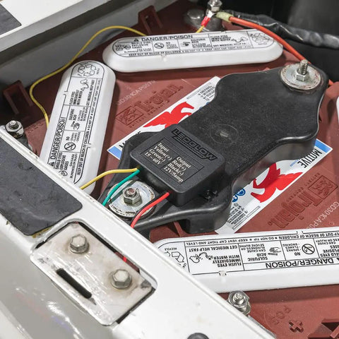 Tough Electric Golf Cart Voltage Step Down Adapter Drops 24 36 48 Or 72 Volts To Solid 12 Volt Power, installed on a battery.