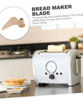 Stirring Paddle Replacement For Bread Maker Reusable Kneading Mixer Blade Spare Part shown next to a silver bread machine in kitchen.