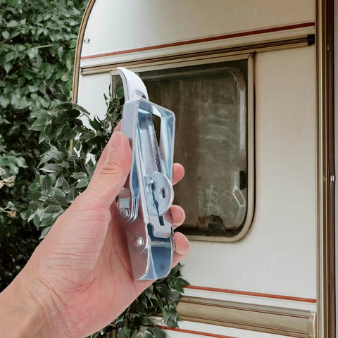 Hand holding RV Cabinet Door Latch and Trailer Gate Latch Kit with adjustable heavy duty metal over center toggle clamp
