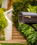Mapleton Heavy Duty Steel Post Mounted Mailbox For Outdoor Use In Rubbed Bronze Finish in garden by walkway