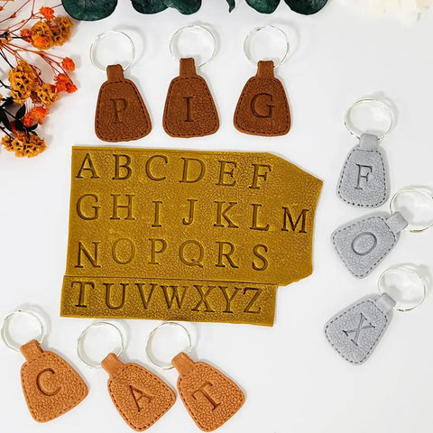 Dope 26 Piece Alphabet Polymer Clay Cutters Set Uppercase Letters shown on clay with keychains and flowers