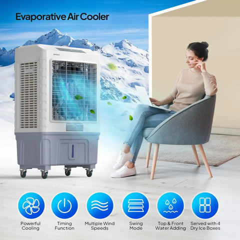 Heavy Duty 13.2 Gallon Evaporative Air Cooler And Portable Swamp Fan With Remote 4100 CFM Airflow 3 Speed Settings next to a woman using a laptop.