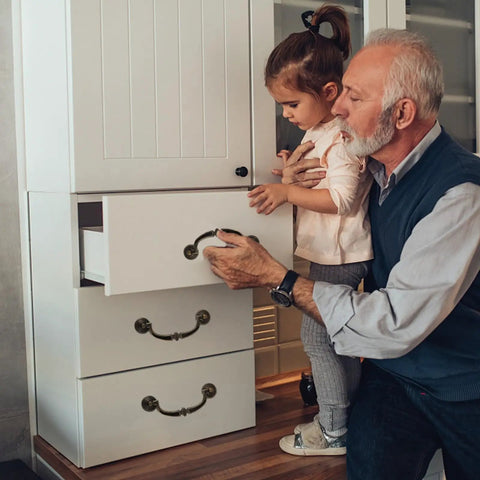Grandfather and granddaughter using Vintage Zinc Alloy Cabinet Pull Handles 4 Pack for Furniture Doors and Drawers on white dresser.