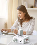 Smooth Operator Eight Outlet Power Strip With Six Foot Flat Plug Extension Cord, woman using laptop with power strip.