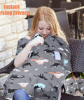 Woman using All In One Baby Car Seat Cover And Nursing Shield With 360 Degree Full Coverage Peekaboo Opening Cozy Minky Blanket, Dinosaur print in outdoor setting