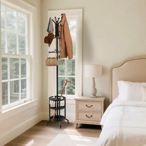 Dope Freestanding Coat Rack With 12 Hooks And Umbrella Holder in bedroom next to window and nightstand.