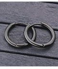 Black Titanium Hoop Earrings 2.5x10mm For Women And Men, Simple Circle Hoops, Hypoallergenic Durable Jewelry on wooden surface