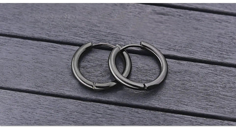 Black Titanium Hoop Earrings 2.5x10mm For Women And Men, Simple Circle Hoops, Hypoallergenic Durable Jewelry on wooden surface