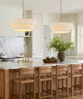 Hand Woven Rattan Chandelier Serving Real Boho Vibes And Adjustable Coastal Design over a kitchen island with marble countertop.