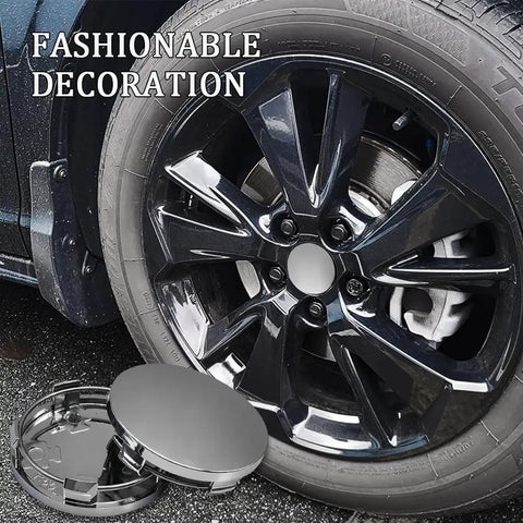 Clean 4 Piece Silver Wheel Center Caps Boast A Snappy Snap Fit And Bulletproof Abs Shield To Shut Out Road Gunk Beat Rust On Hub Studs And Keep Your Rims Looking Fresh On Daily Cruises. Close-up of a shiny silver wheel center cap beside a black alloy wheel.