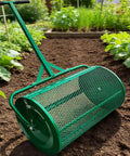 Green 24-inch compost spreader roller on a garden path, designed for even distribution of peat moss, topsoil, and fertilizer.