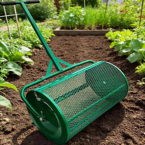 Green 24-inch compost spreader roller on a garden path, designed for even distribution of peat moss, topsoil, and fertilizer.