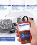 Hand holding OBD2 Scanner For Cars Universal OBDII CAN Diagnostic Tool Read And Clear Check Engine Light Fault Codes