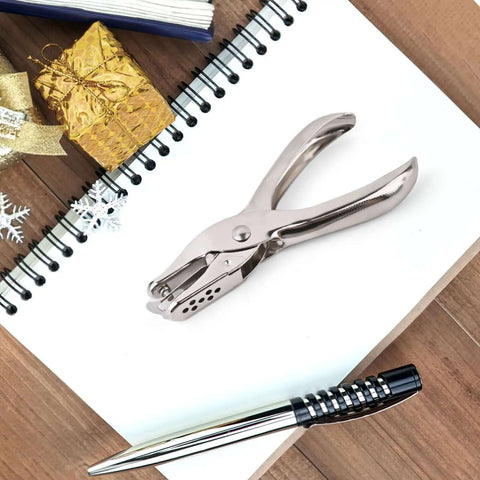 Seventeen Piece One Eighth Inch Circle Hole Punch Set for crafts on a desk with notepad and pen, durable metal construction