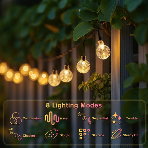 Solar String Lights For Outdoor 20Ft 30 LED Crystal Globe Fairy Lights Warm White With 8 Lighting Modes hanging on a garden fence
