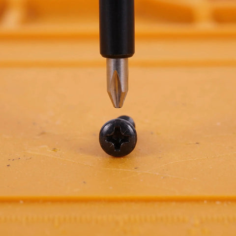 Grab These Happyyami M4x14mm Black Pan Head Self Tapping Screws With Cross Recess And Flat Point, Perfect For Wood Cabinet Hardware And Small Machine Assemblies, 200 Piece Set. Close-up of black screw and screwdriver.