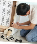 Man assembling furniture using the Complete Heavy Duty 170 Piece Steel Furniture Screw And Nut Kit With Robust Bolt Connectors For Bedroom Assembly.