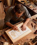 Craftsman using Top Shelf Acrylic Router Template Kit For Woodworkers with festive designs on a wood project.