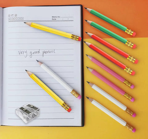 Premium 25-Pack Hexagonal Wooden Golf Pencils with Built-In Erasers and Graphite 2B Lead in assorted colors next to a notebook.