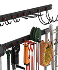 Garage Tool Organizer Wall Mount System With 64 Inch Rails And Eight Heavy Duty Adjustable Hooks displayed with tools and a ladder