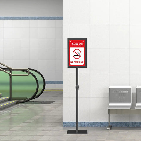 Heavy Duty 11x17 Standing Sign Holder With Adjustable Pedestal in indoor hallway, displaying 'No Smoking' sign