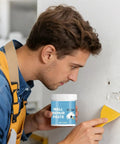 Man applying Wall Repair Paste For Quick Fix And Seamless Finish, Waterproof Drywall Crack Filler For Home Renovation, 200g, to a wall hole.