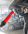 Close-up of red 10-ton hydraulic floor jack pump for automotive repair.