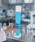 4 Pack Plastic Graduated Cylinders Thickened Clear Plastic With Hexagonal Spill Resistant Base For Precise Calibration In Kid Friendly Lab Learning Science Classroom Supplies Industrial Measuring, clear cylinder held in lab