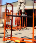 Person standing on Built Tough Electric Lift Cart Heavy Duty Cargo Elevator Platform Anti Slip Deck in outdoor setting.