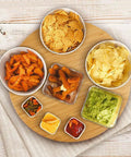 20 Inch Extra Large Bamboo Lazy Susan Turntable Round Rotating Serving Tray For Kitchen And Dining Tables Ideal For Parties Eco Friendly Solid Bamboo Construction With Smooth Spin And Durable Heavy Duty Support with snacks displayed.