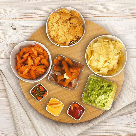 20 Inch Extra Large Bamboo Lazy Susan Turntable Round Rotating Serving Tray For Kitchen And Dining Tables Ideal For Parties Eco Friendly Solid Bamboo Construction With Smooth Spin And Durable Heavy Duty Support with snacks displayed.