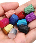 Colorful knurled thumb nuts in hand, multi-color anodized, assorted sizes for electronics, machinery, DIY projects.