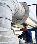 Ceramic fiber blanket insulation installed around a large metal pipe; gray heat-resistant fireproof material