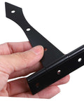 Hand holding heavy duty cabinet door hinge, black iron