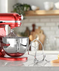 7Quart Stainless Steel Flat Beater for Stand Mixer Replacement Paddle Attachment next to red KitchenAid mixer on counter